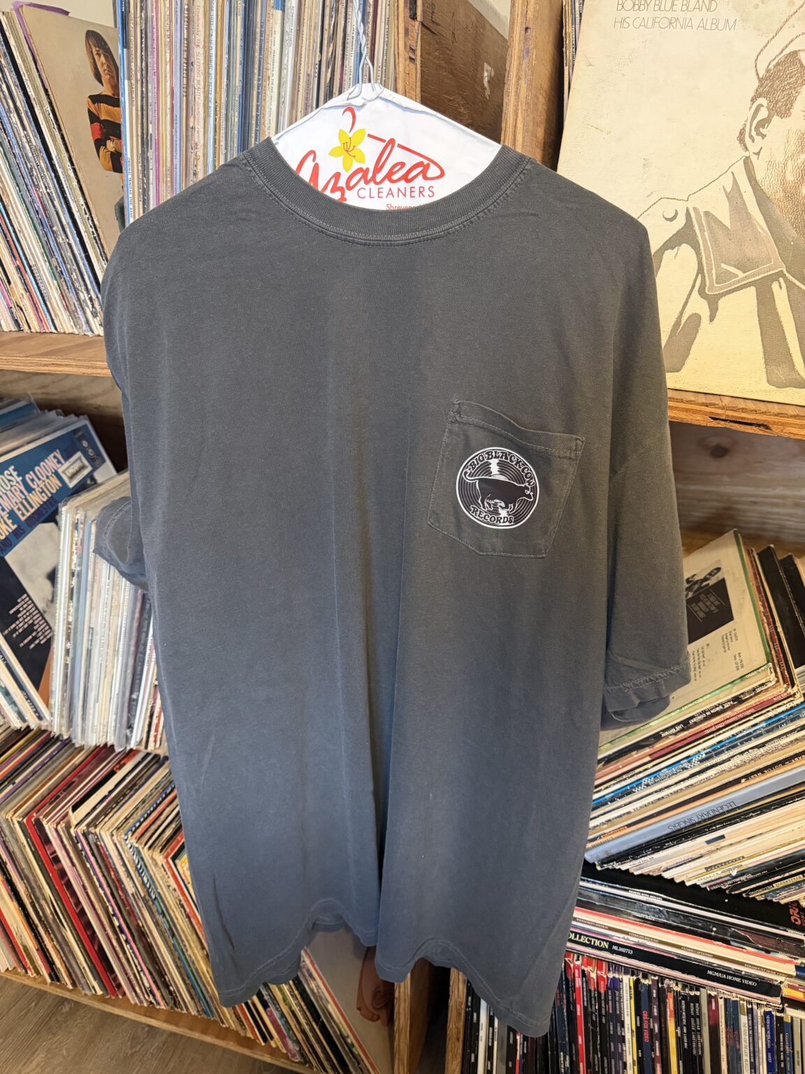 Small BBCR logo printed on the front pocket of a gray shirt