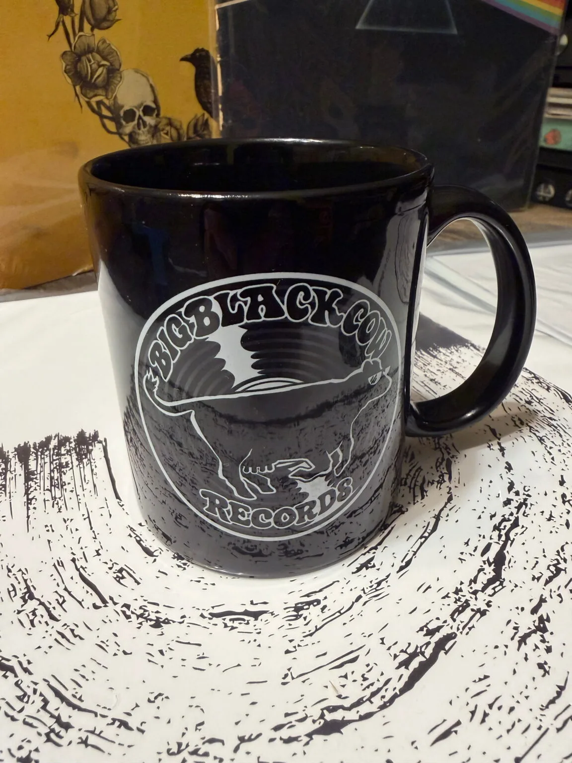 Black coffee mug printed with the white BBCR cow and record logo